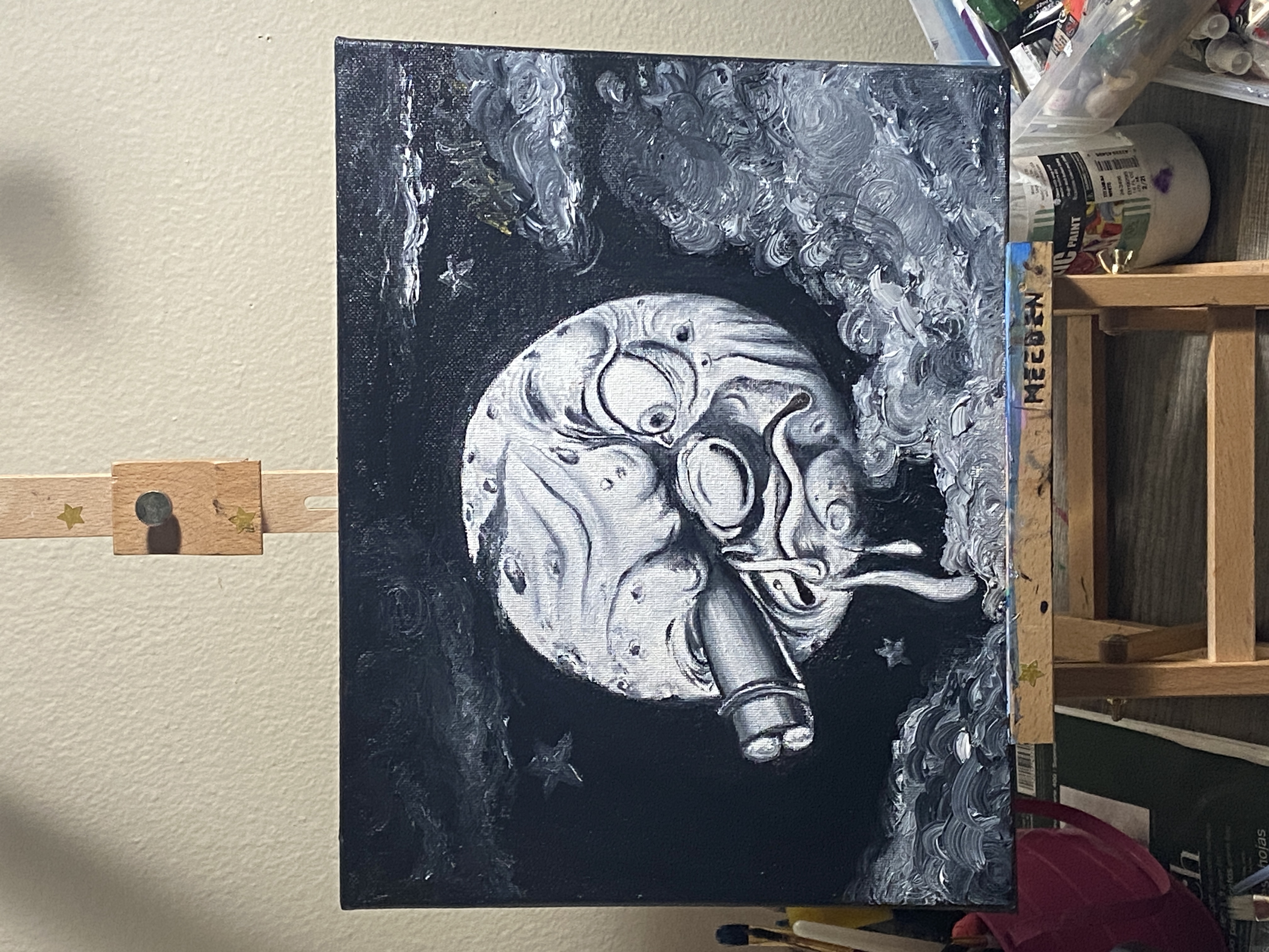 Black and white moon painting on an easel